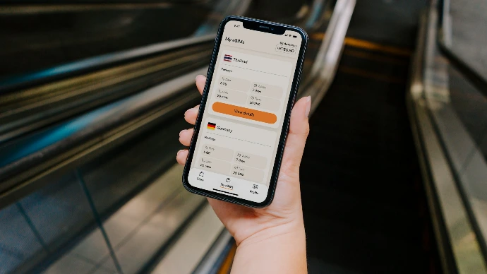 Person holding smartphone with currency exchange app open